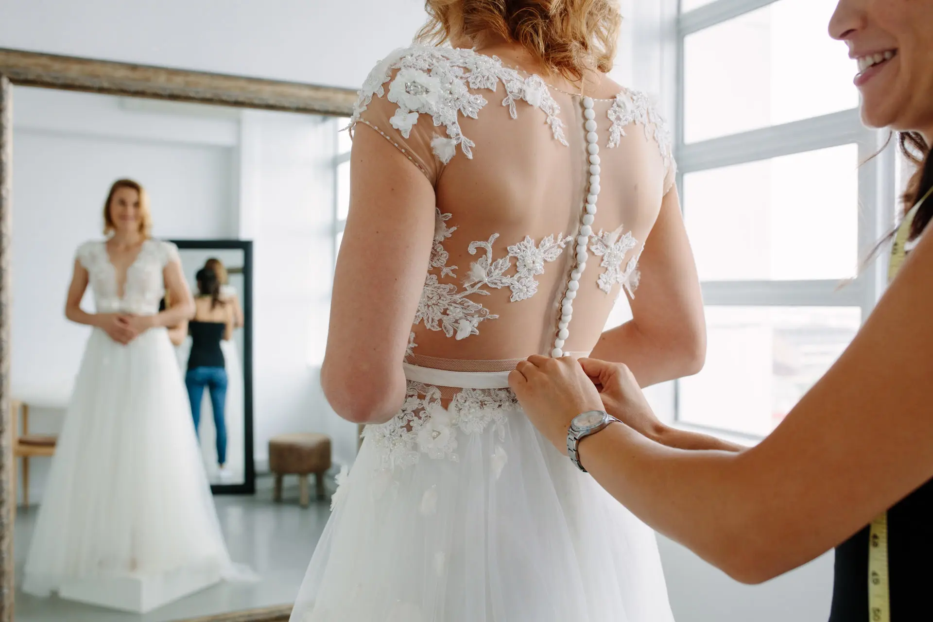 Bride getting fitted for wedding dress.